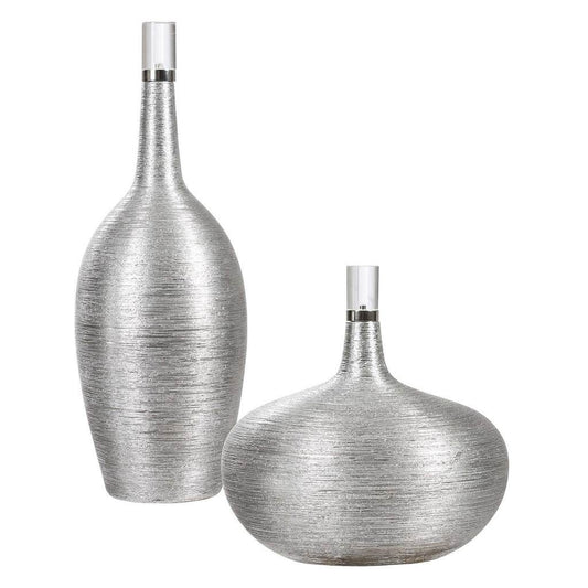 Front View. Set of two ceramic bottles showcase a subtle ribbed texture, finished in bright silver l