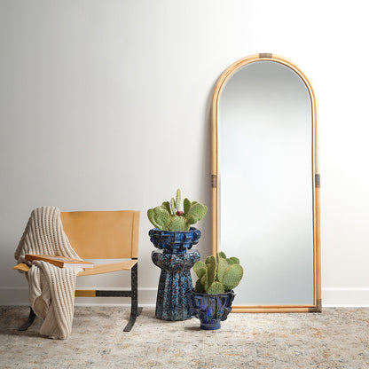 Decorative View. This gently arched, full length floor mirror’s rattan frame is subtly embellished w