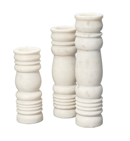 Front View. Beautifully artisan-carved of cool white stone, this set of three candlesticks pair clas