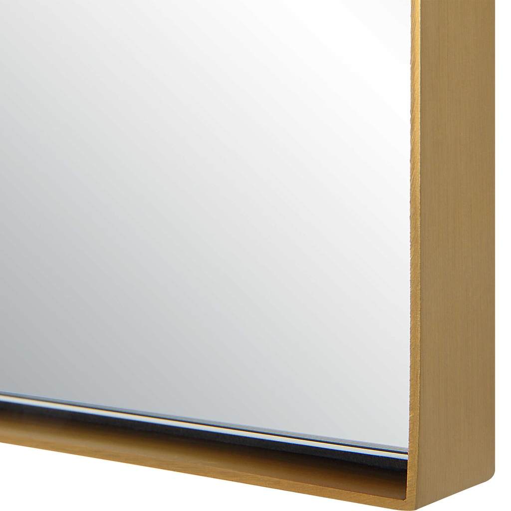 Close-Up View. Crafted with a sleek stainless steel frame, the tordera arch mirror features a brass 
