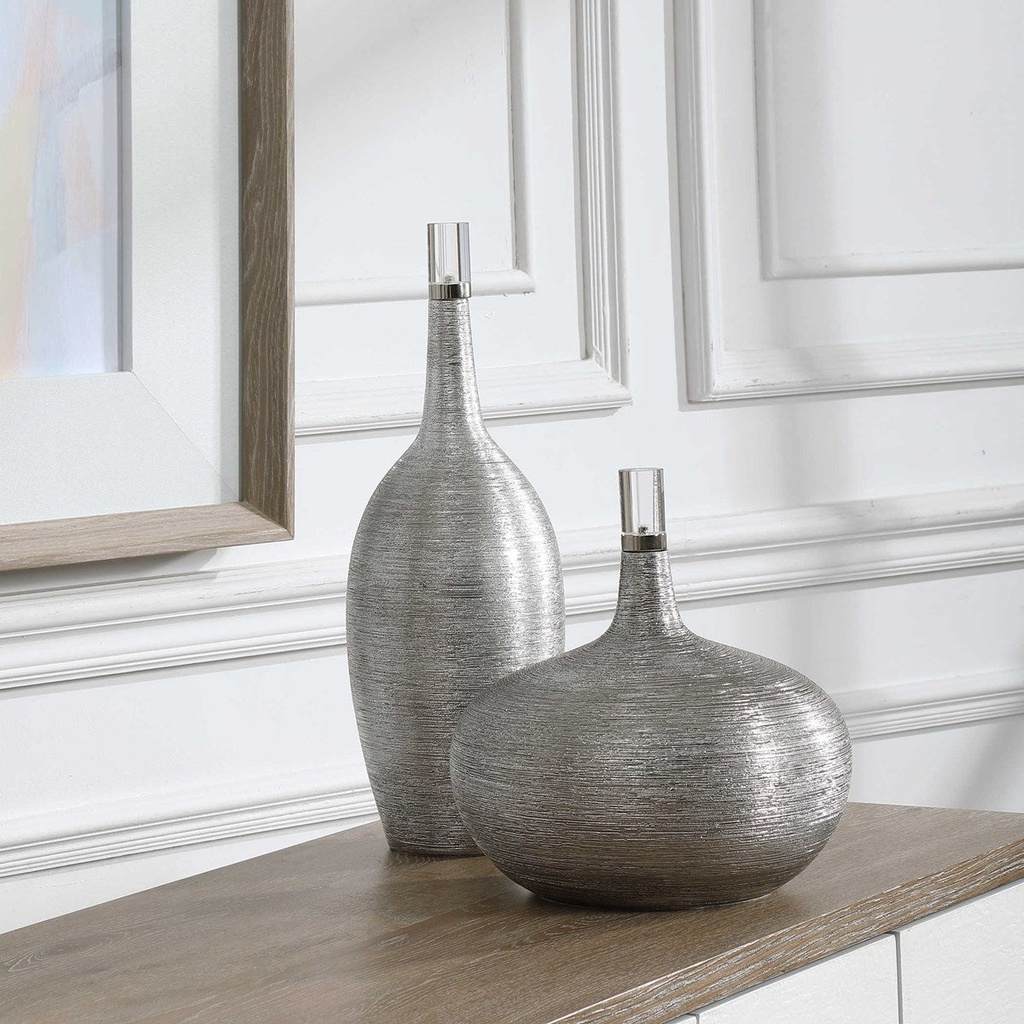 Decorative View. Set of two ceramic bottles showcase a subtle ribbed texture, finished in bright sil