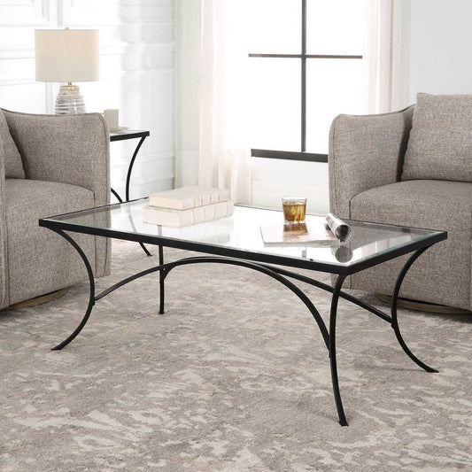 Decorative View. The Alayna Coffee Table features gracefully arched hand forged metal that is finish