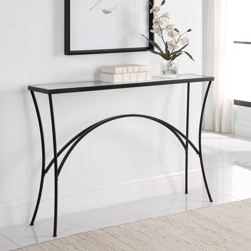 Decorative View. The Alayna Console Table features gracefully arched hand forged metal that is finis