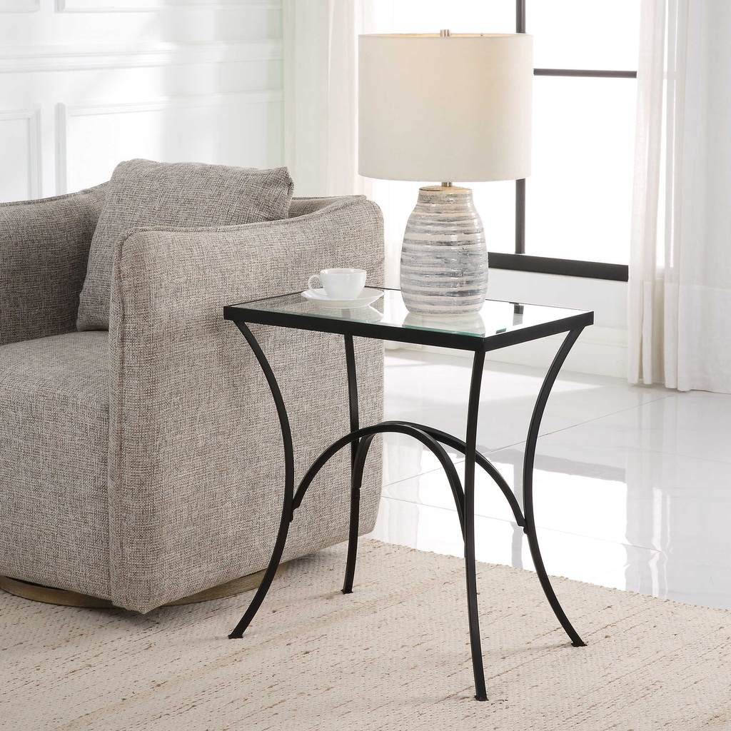 Decorative View. The Alayna End Table features gracefully arched hand forged metal that is finished 