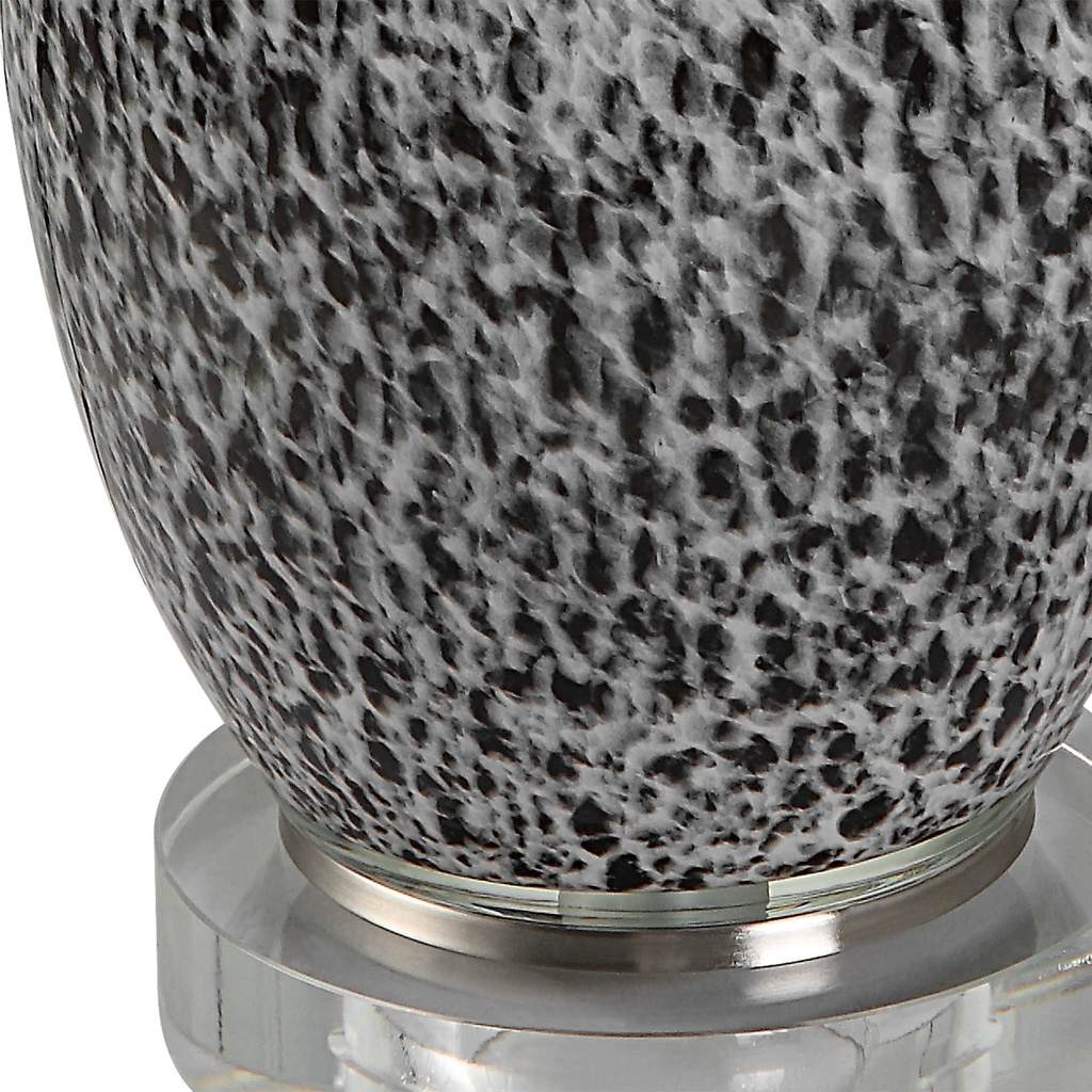 Close-Up View. The Velino Curvy Glass Table Lamp base features a soft gray background with mottled b