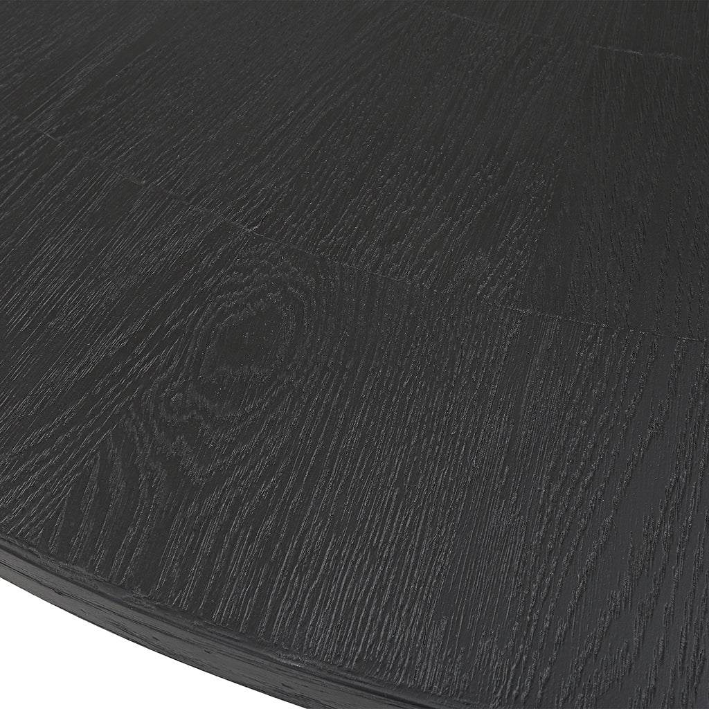 Close-Up View. With clean casual styling, the Gidran round dining table features a richly grained oa